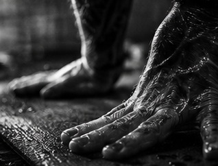 Sweating hands pressed into a yoga mat